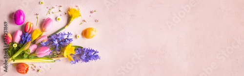 Colorful signs of spring for happy easter greetings on tender pink. Horizontal background for greeting cards and banner. Top view.