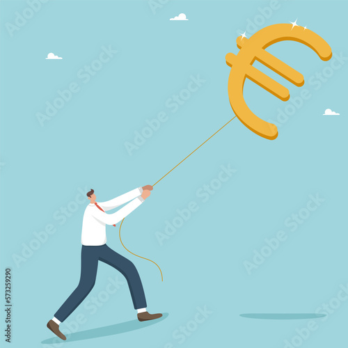 Achieving financial goals or an investor in search of profit and return on investment, a successful businessman pulling a euro balloon. Opportunity to receive a large salary, income or profit.