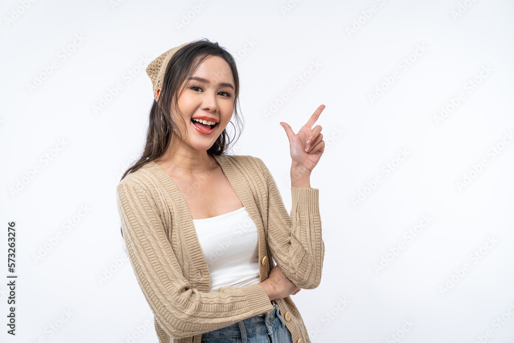 Happy Asian woman is smiling and pointing finger to copy space isolated on white background. Happy Asian woman is smiling and pointing finger to copy space isolated on white background.