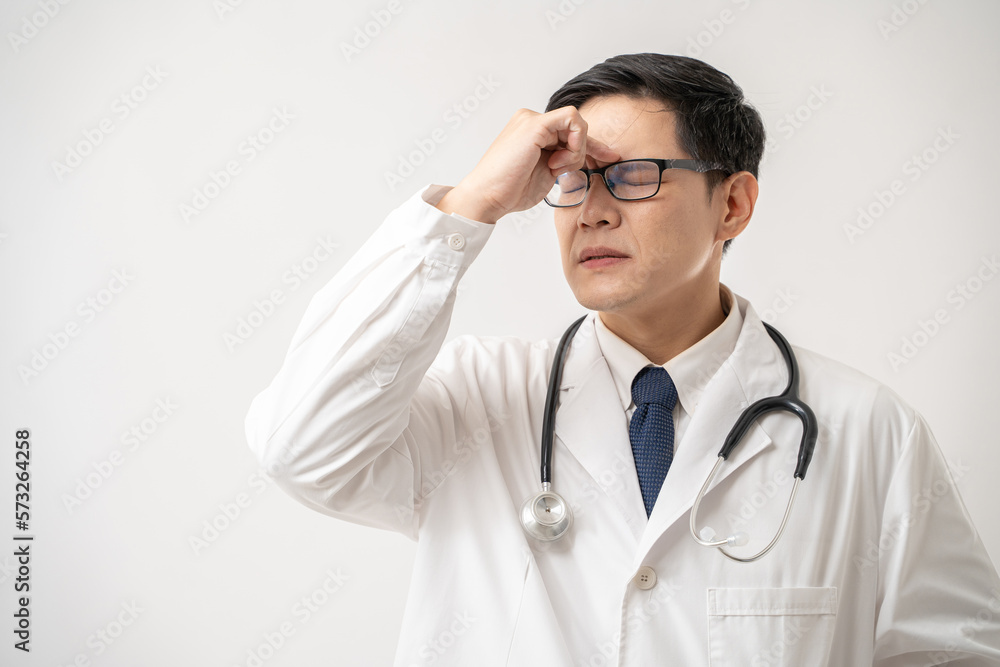 Portrait of stress Asian Doctor in glasses with stethoscope stress headache about work isolated on white background Portrait of stress Asian Doctor in glasses with stethoscope stress headache about work isolated on white background