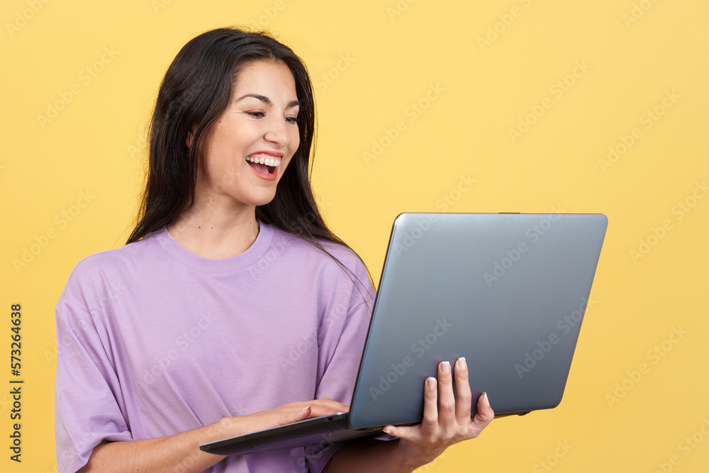 Caucasian woman smiling while using a laptop Caucasian woman smiling while using a laptop
