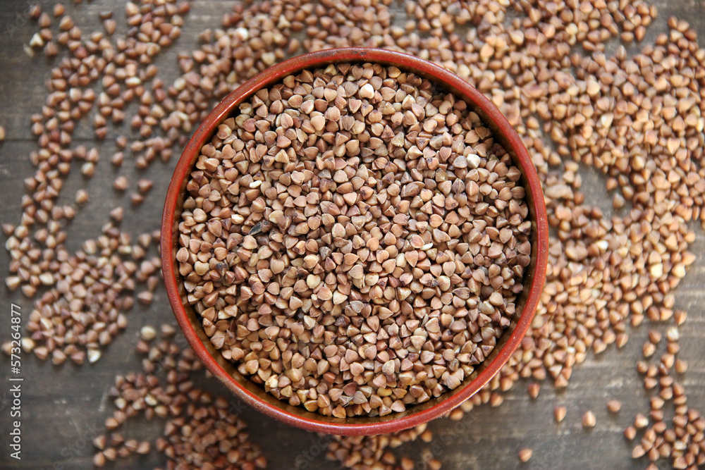 Peeled groats of buckwheat on the background wood Peeled groats of buckwheat on the background wood