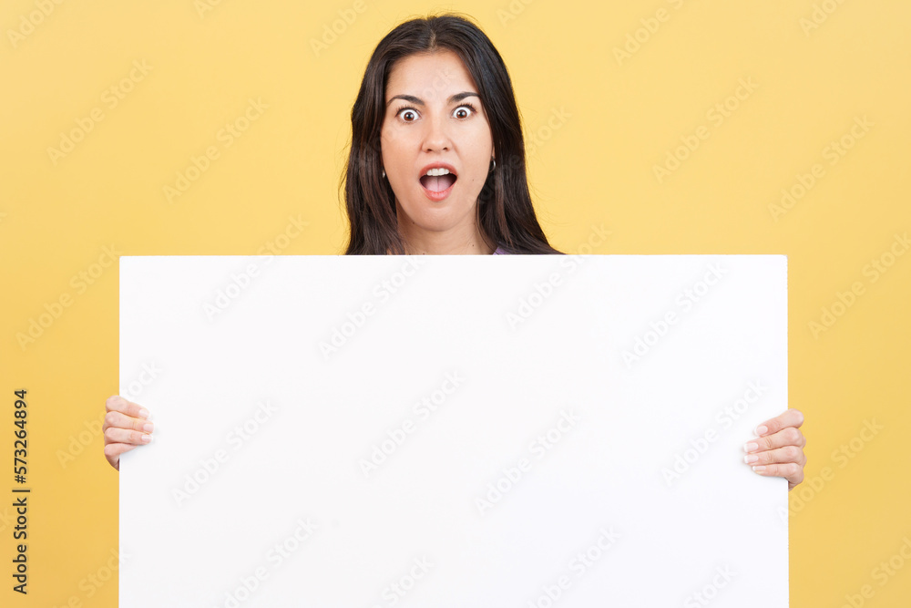 Amazed caucasian woman hair holding a blank panel Amazed caucasian woman hair holding a blank panel