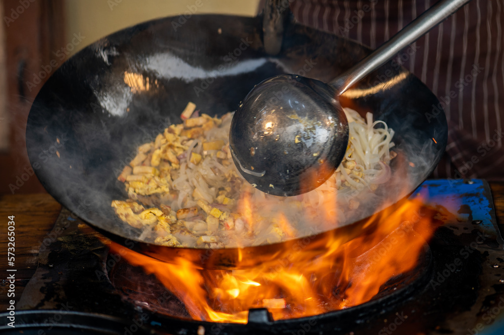 Pad Thai favorite and famous Asian Thai street fast food in hot pan, Pad Thai is stir fried rice noodle dish commonly served as a street food and at casual local eateries in Thailand