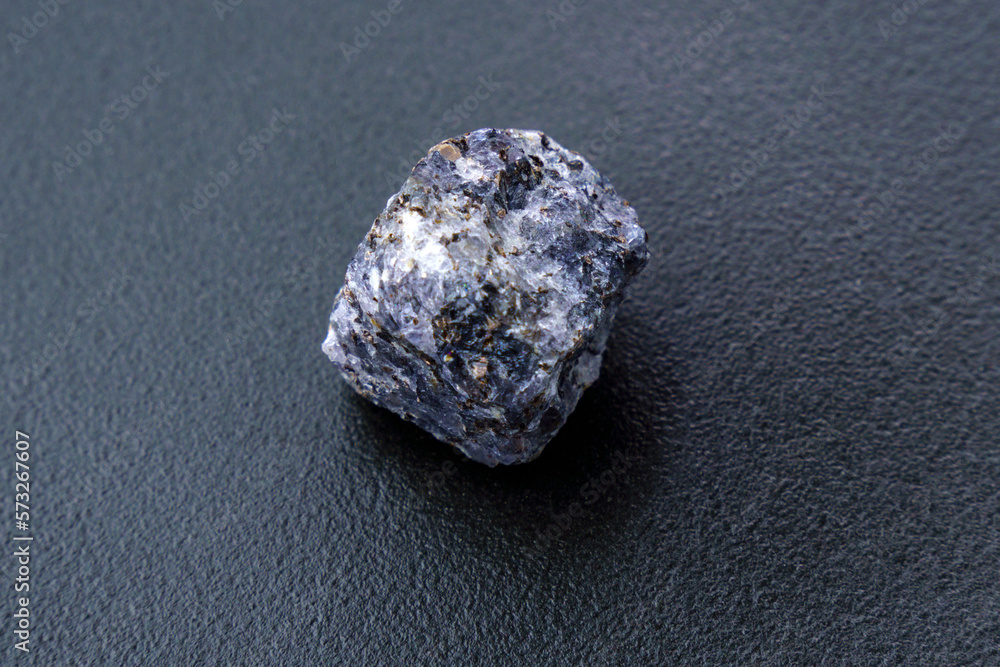 Naklejka premium Natural mineral stone cordierite gemstone, geological collection raw crystal