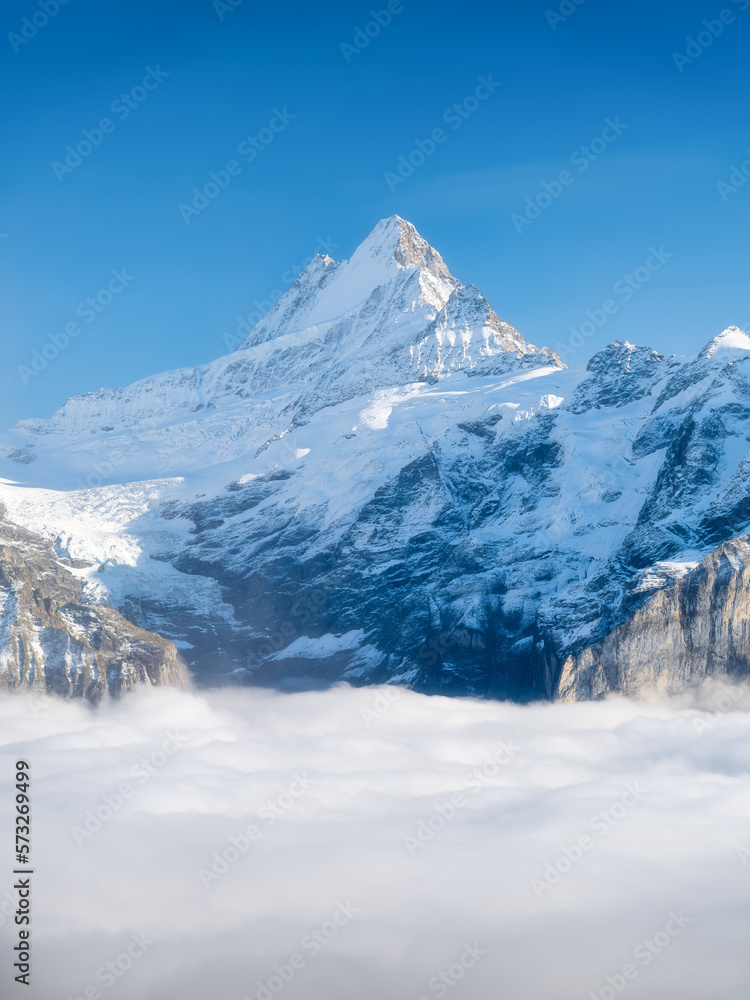 Obraz premium Mountains peaks and clouds in the valley. Natural landscape. Mountain range through the clouds. Landscape in the summertime.