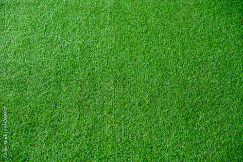 Green artificial grass natural background texture soccer field.