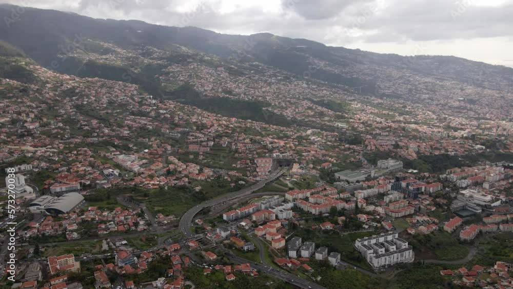 Aerial view the city of Funchal, capital of Madeira, Portugal. View of entire city and the mountains in the background. Aerial view the city of Funchal, capital of Madeira, Portugal. View of entire city and the mountains in the background.