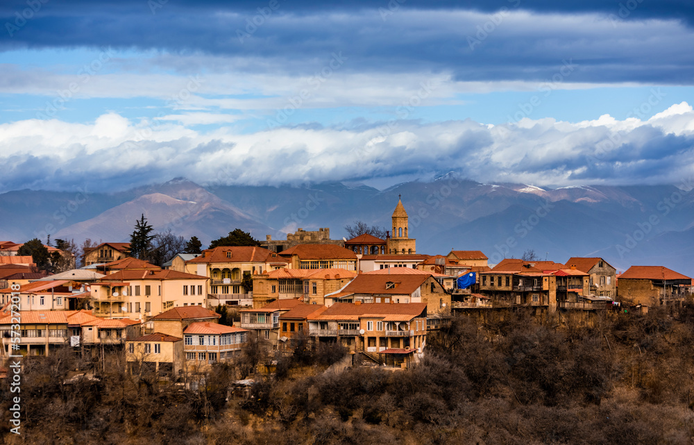 Autumn view on the town of Signagi and Alazani valley in Kakheti region, Georgia. Georgian touristic town of love. Dramatic sky with mountains in the background.