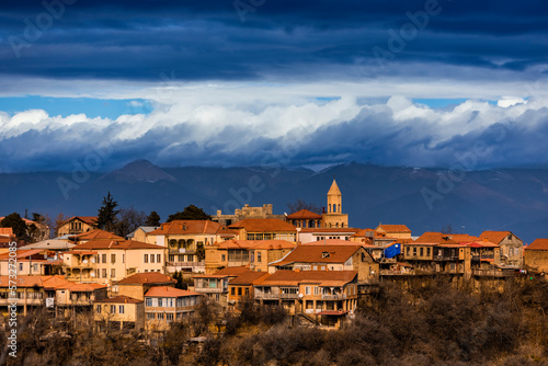 Autumn view on the town of Signagi and Alazani valley in Kakheti region, Georgia. Georgian touristic town of love. Dramatic sky with mountains in the background. photo