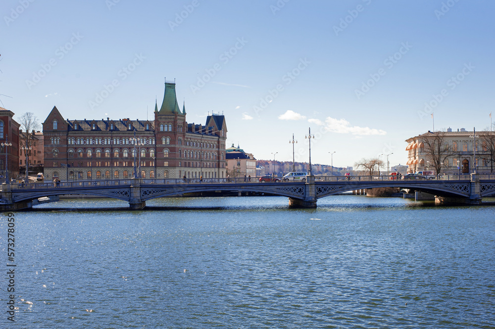 view of stockholm city hall stadhuset from the frozen river with melting ice