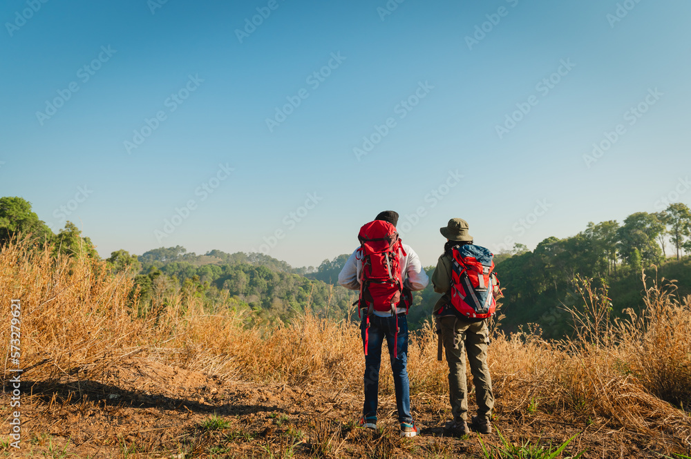 traveler couple with backpack standing looking view on mountain
