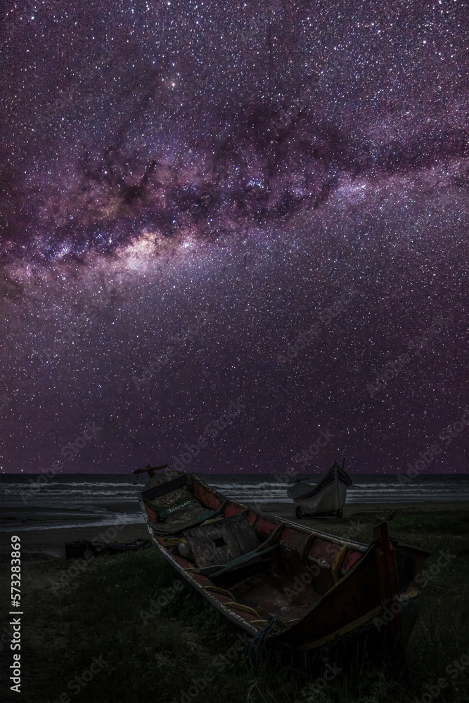 Serenity by the Shore: Fishing Boats under the Milky Way at Night