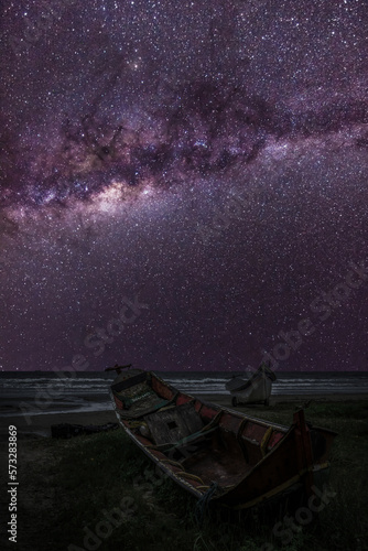 Serenity by the Shore  Fishing Boats under the Milky Way at Night in Brazil. Two Wooden Fishing Boats at the Beach.