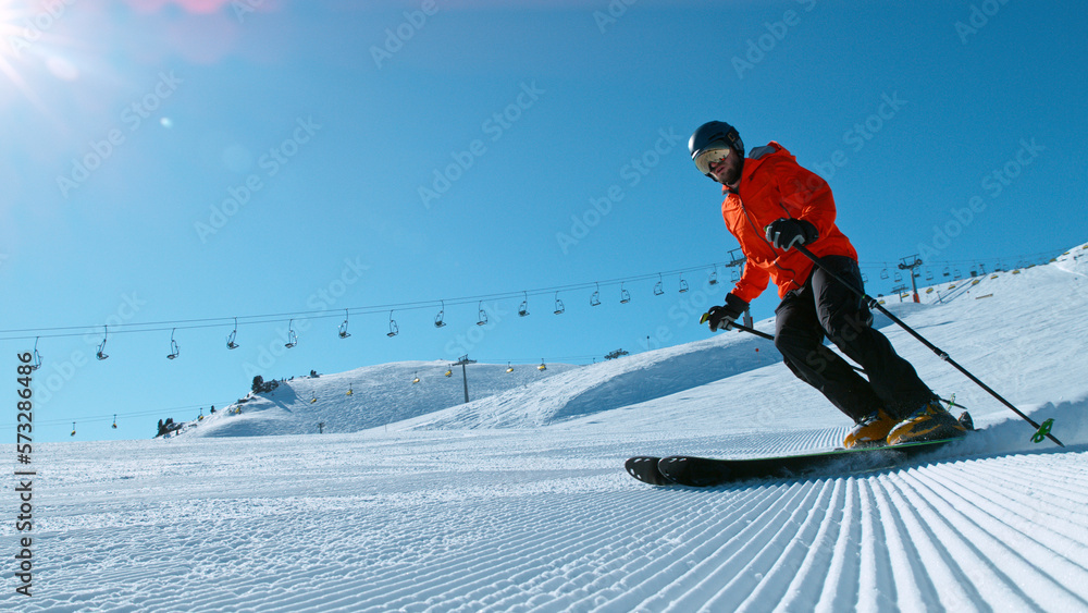 Freeride skier riding in the scenic mountains with blue sky
