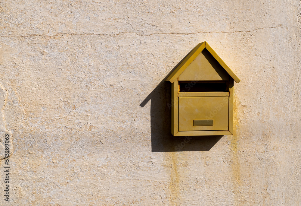 yellow mail box on wall