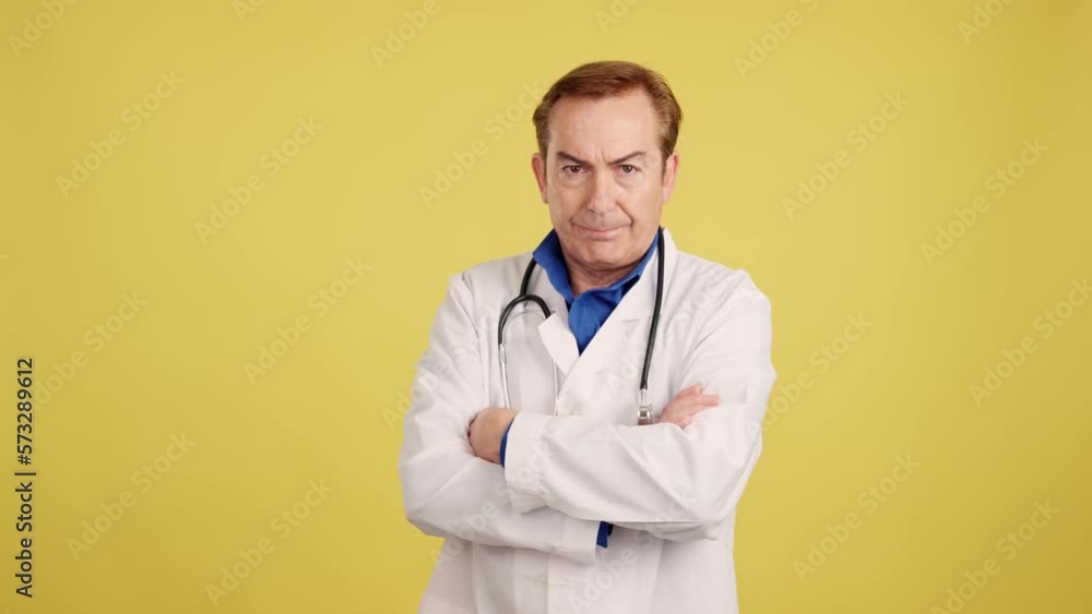 Serious doctor looking at the camera with arms crossed Serious doctor looking at the camera with arms crossed