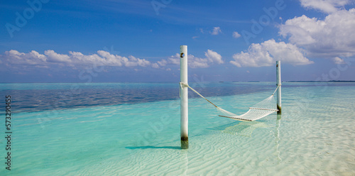 Relax vacation leisure lifestyle on exotic tropical island beach, aerial water hammock hanging calm sea. Paradise beach landscape tranquil carefree sunrise sky clouds amazing. Beautiful nature freedom