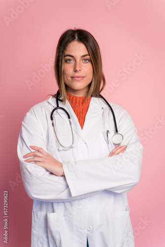 Doctor with stethoscope on pink background