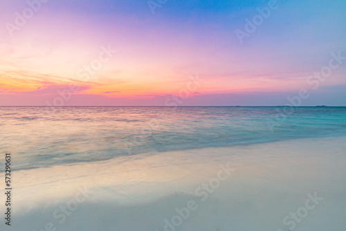 Closeup sea sand beach. Long exposure beach landscape. Inspire tropical beach seascape horizon. Dream colorful sunset sky. Calming tranquil meditation sunlight. Beautiful orange coast wave water