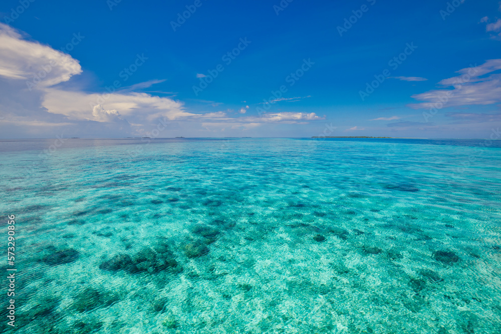 Summer seascape tranquil blue sea water in sunny day. Sea aerial view, amazing tropical nature background. Beautiful bright sea lagoon bay with waves splashing and beach sand concept. Relaxing ocean