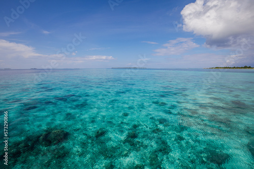 Summer seascape tranquil blue sea water in sunny day. Sea aerial view, amazing tropical nature background. Beautiful bright sea lagoon bay with waves splashing and beach sand concept. Relaxing ocean
