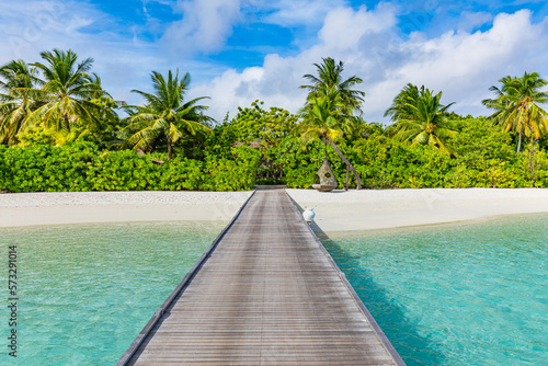 Amazing beach panorama at Maldives. Luxury resort pier bridge sea bay with palm trees, tropical shore white sand. Tranquil relaxing landscape, wellbeing sunny island. Honeymoon summer vacation concept