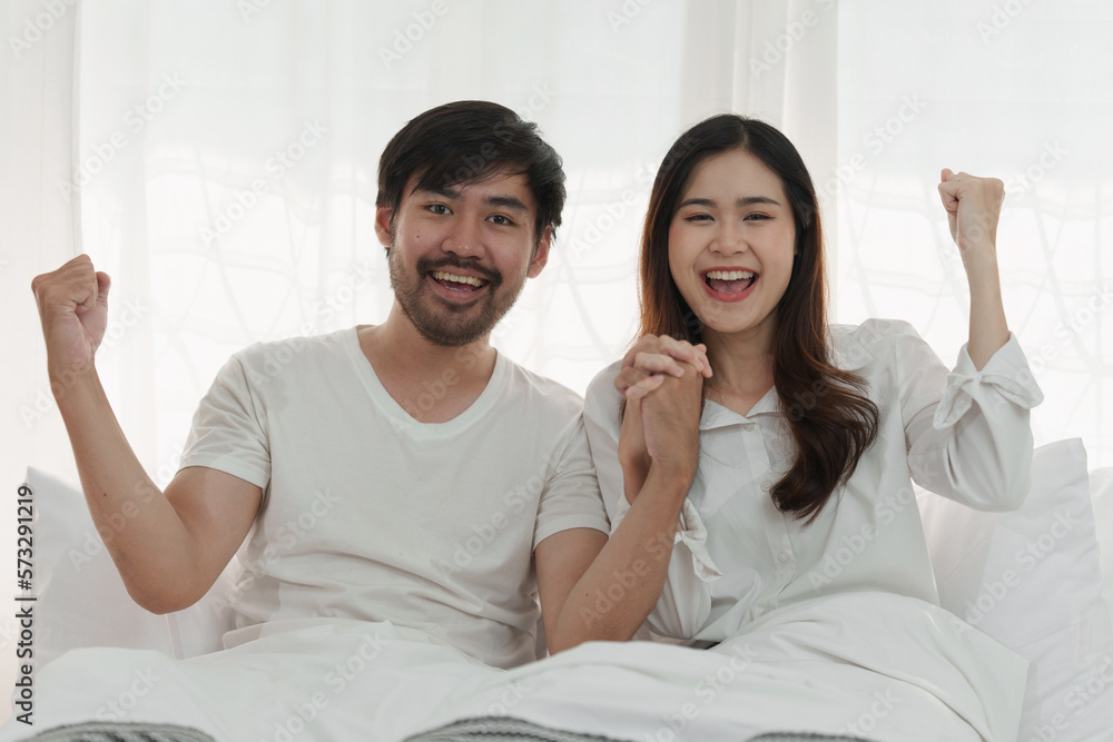 Beautiful asian couple in love and smiling sitting on bed. Romantic moment, relationships, family concept. Beautiful asian couple in love and smiling sitting on bed. Romantic moment, relationships, family concept.
