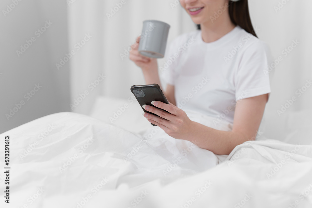 Portrait of Good Healthy woman drinking tea and resting in bed at bedroom. Lifestyle at home concept Portrait of Good Healthy woman drinking tea and resting in bed at bedroom. Lifestyle at home concept