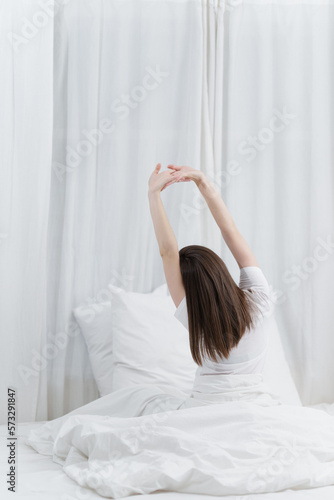 Wallpaper Mural Image of beautiful young woman resting in bed at bedroom. Lifestyle at home concept. Torontodigital.ca