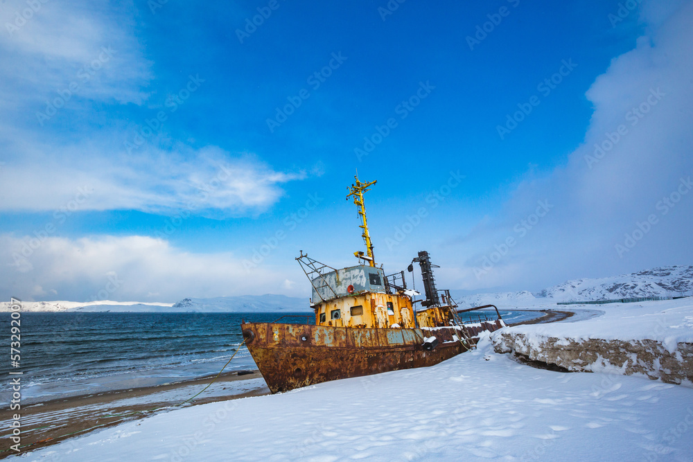 Ship near Teriberka, Barents Sea bay. Kola Peninsula winter landscape. Russia