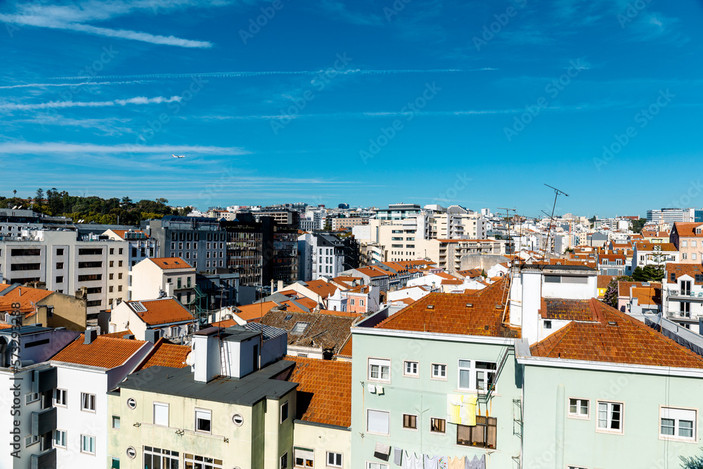 A plane flying in the sky of Lisbon, Portugal