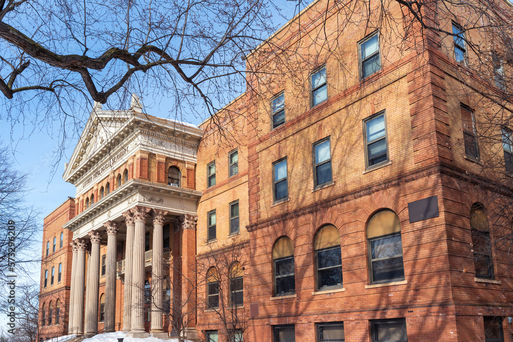 Fototapeta premium corner of landmark seminary building and front entrance in st anthony park neighborhood of saint paul minnesota