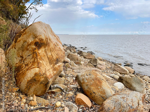 Rocky section of the shore of Lake Khanka in autumn. Russia, Primorsky Krai photo