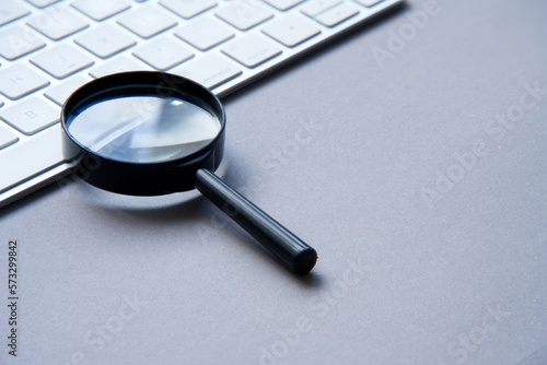 Search engine optimization. Keyboard and magnifying glass.