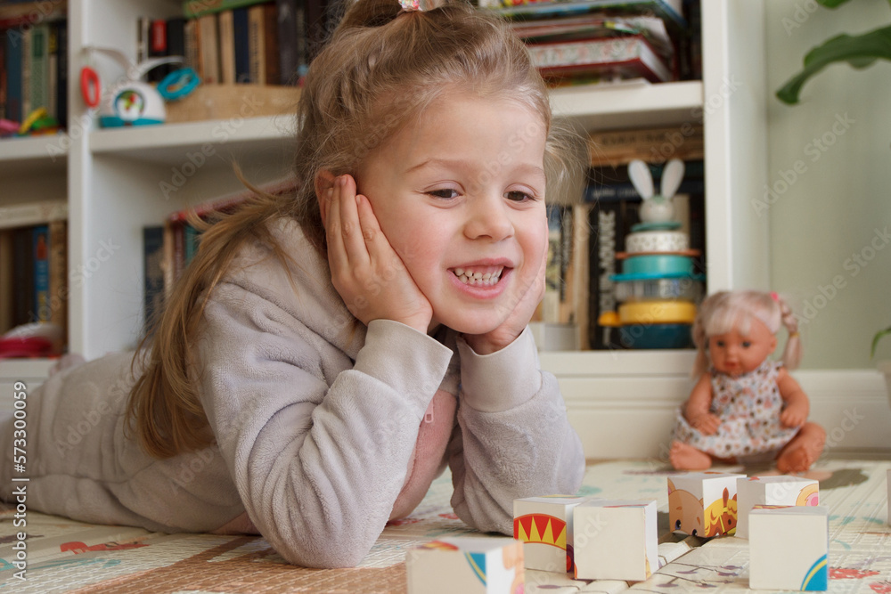 Little cute girl spending time in the playroom