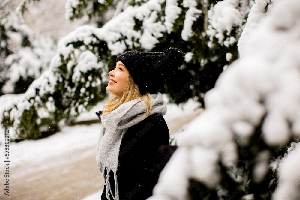 Young woman in warm clothes enjoying in snow Young woman in warm clothes enjoying in snow