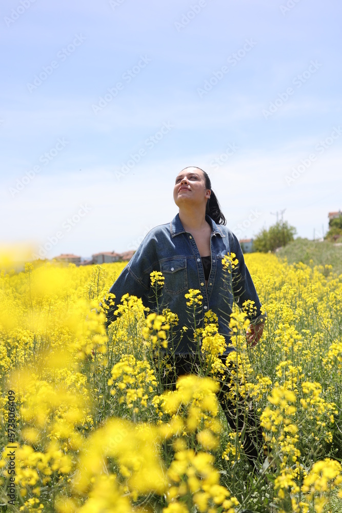 Young beautiful woman in canola field. Freedom, self-confident and youth concept. Young beautiful woman in canola field. Freedom, self-confident and youth concept.