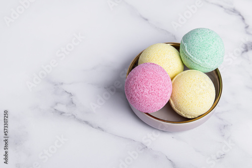 Colorful bath bombs on ate. Home spa. Space for text