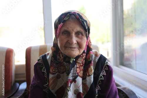 Old, elderly turkish woman with hijab. She has wrinkles on her face.