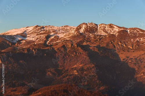 The Lombard pre-Alps near Lake Iseo, seen at sunset from one of the most beautiful viewpoints in the Province of Brescia: Punta Almana, near the town of Sale Marasino, Italy - February 2023.