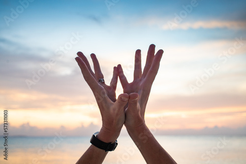 hand in lotus mudra at sunset photo