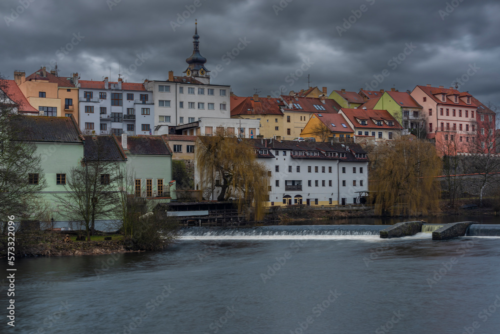 Old stone bridge and center of Pisek town in cloudy winter morning