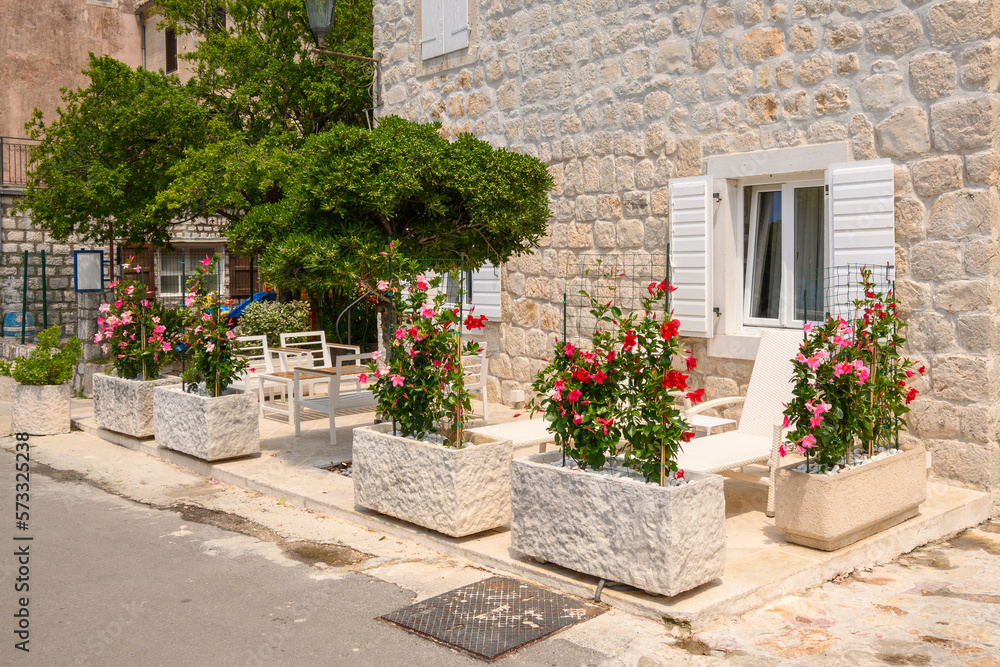 Leisure terrace with sun loungers and flowers. A typical house in the picturesque village of Perast. Montenegro