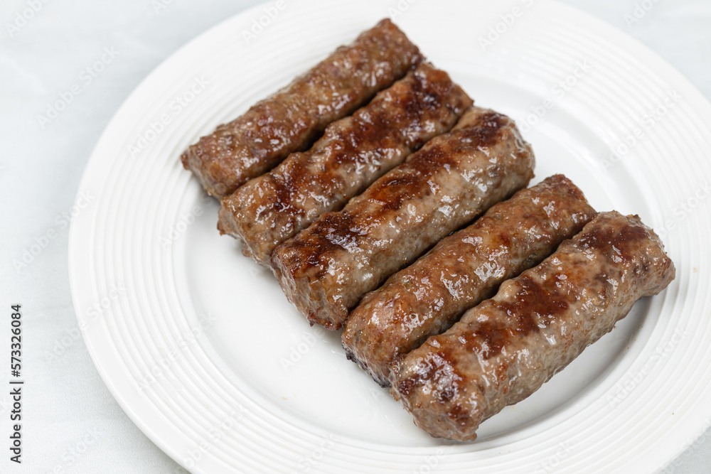 Fresh baked kebabs with minced meat served on the plate Fresh baked kebabs with minced meat served on the plate