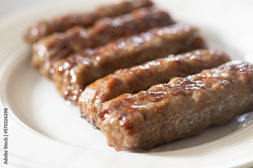 Fresh baked kebabs with minced meat served on the plate Fresh baked kebabs with minced meat served on the plate