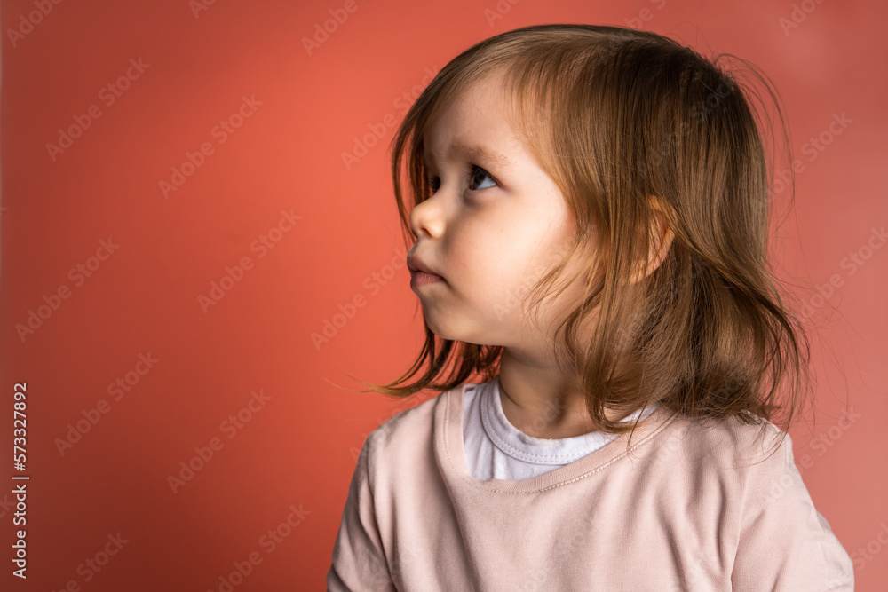 one small caucasian girl 2 years toddler in front of pink background one small caucasian girl 2 years toddler in front of pink background