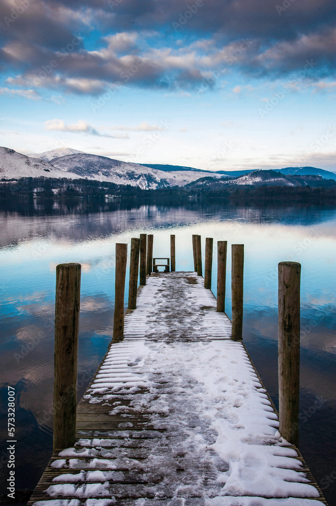 View acroos a Derwentwater landing stage on a snowy winter's day