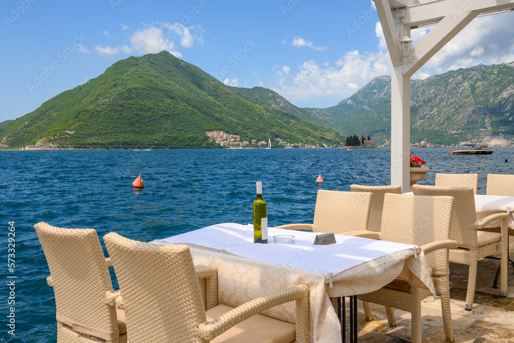 Typical seaside restaurant overlooking the beautiful Bay of Kotor in Montenegro. Europe