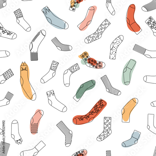 Seamless pattern with doodle socks. Wool, cotton warm accessories with modern patterns. Unisex clothes. Black line and colorful shapes. Vector illustration